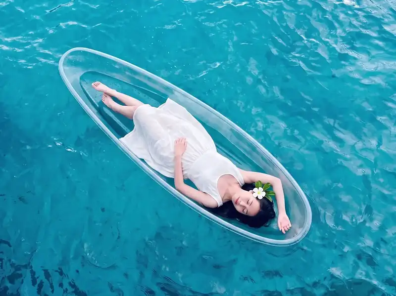 Enjoying a transparent kayak ride through crystal clear waters with Sunny Holiday near the Tun Sakaran Marine Park.