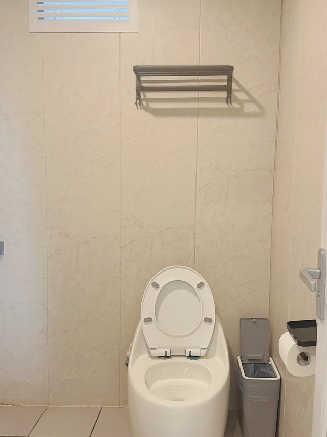 A practical simple bathroom at Sunny Holiday, an over the water resort near Tun Sakaran Marine Park.