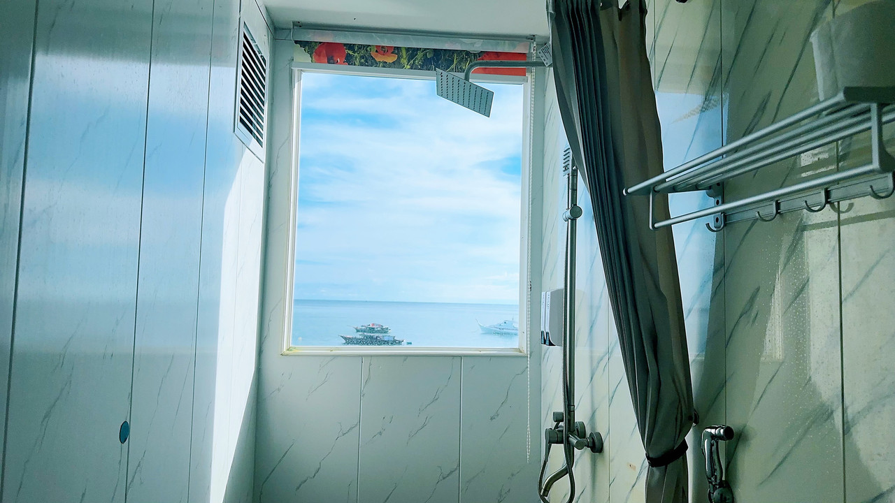 A bright simple bathroom at Sunny Holiday, a water resort in the Semporna archipelago.